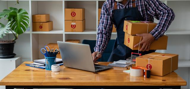 small business owner packing boxes